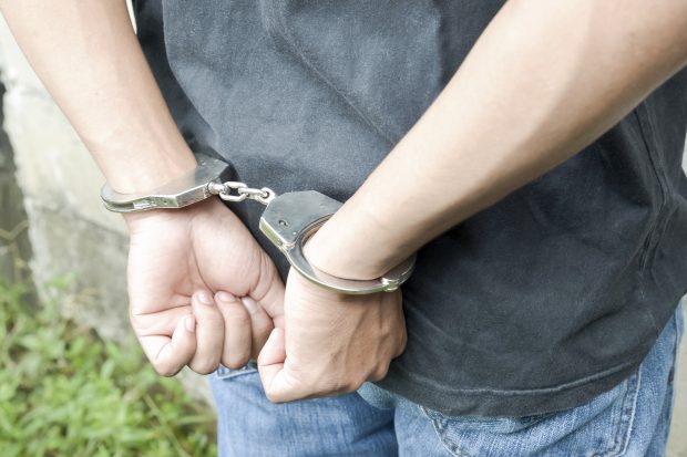 Young man in handcuffs